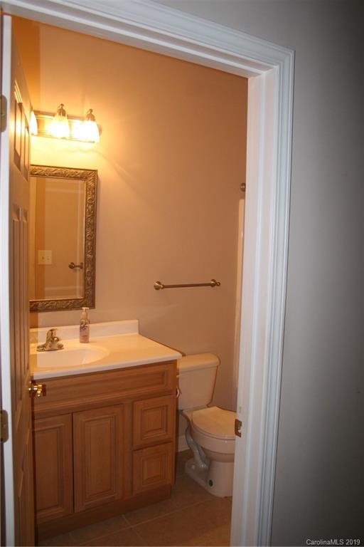 805 Stratford Road Troutman, NC 28166 - Photo 17 of 34 a bathroom with a toilet a sink and a mirror