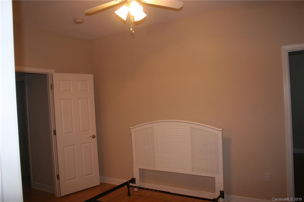 805 Stratford Road Troutman, NC 28166 - Photo 21 of 34 a room with a wooden floor and white walls