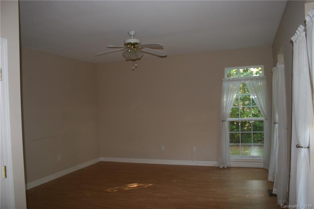 805 Stratford Road Troutman, NC 28166 - Photo 6 of 34 wooden floor in an empty room with a window