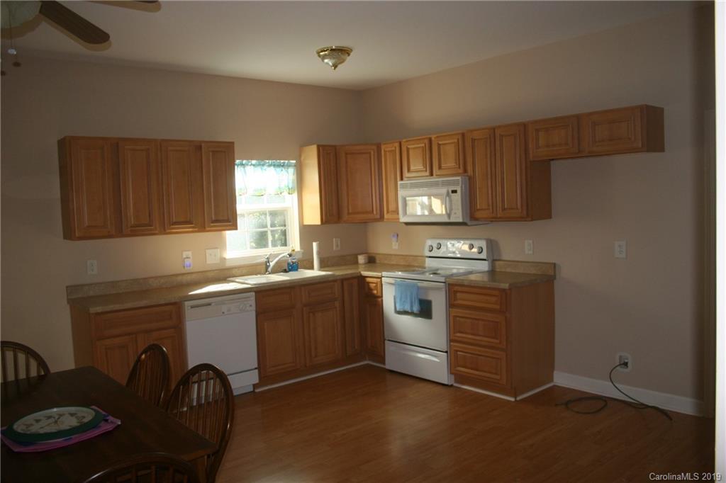 805 Stratford Road Troutman, NC 28166 - Photo 10 of 34 a kitchen with stainless steel appliances granite countertop a stove a sink dishwasher and a refrigerator