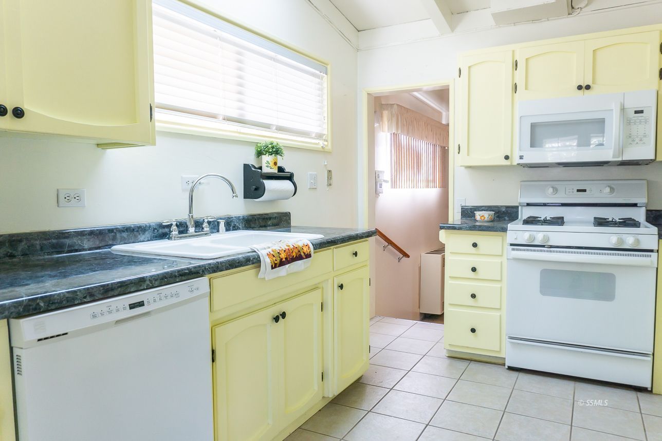 425 North Alvord Street Ridgecrest, CA 93555 - Photo 8 of 43 a kitchen with cabinets appliances a sink and a window