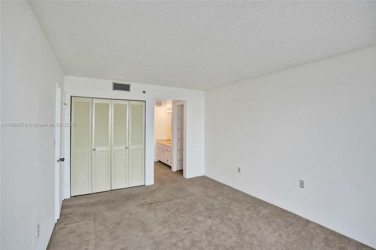 1200 St Charles Place, Unit 413 Pembroke Pines, FL 33026 - Photo 14 of 34 an empty room with closet area