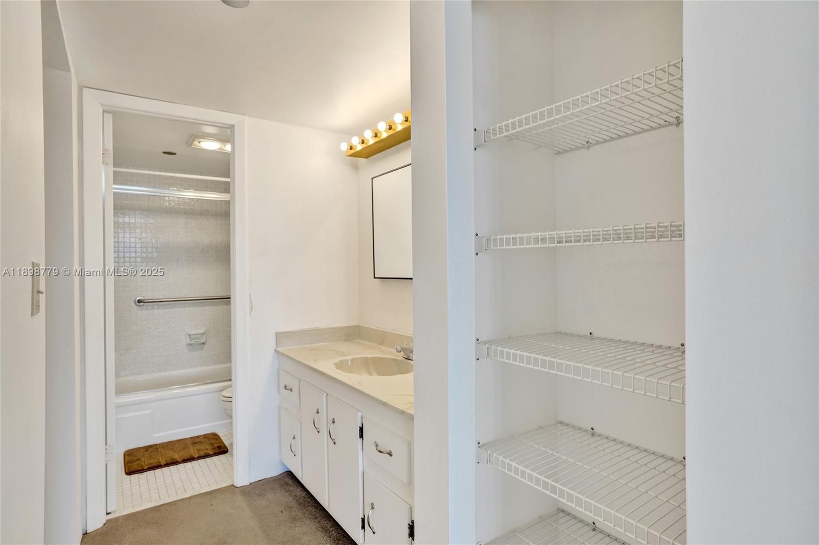 1200 St Charles Place, Unit 413 Pembroke Pines, FL 33026 - Photo 15 of 34 a bathroom with a granite countertop sink and a shower