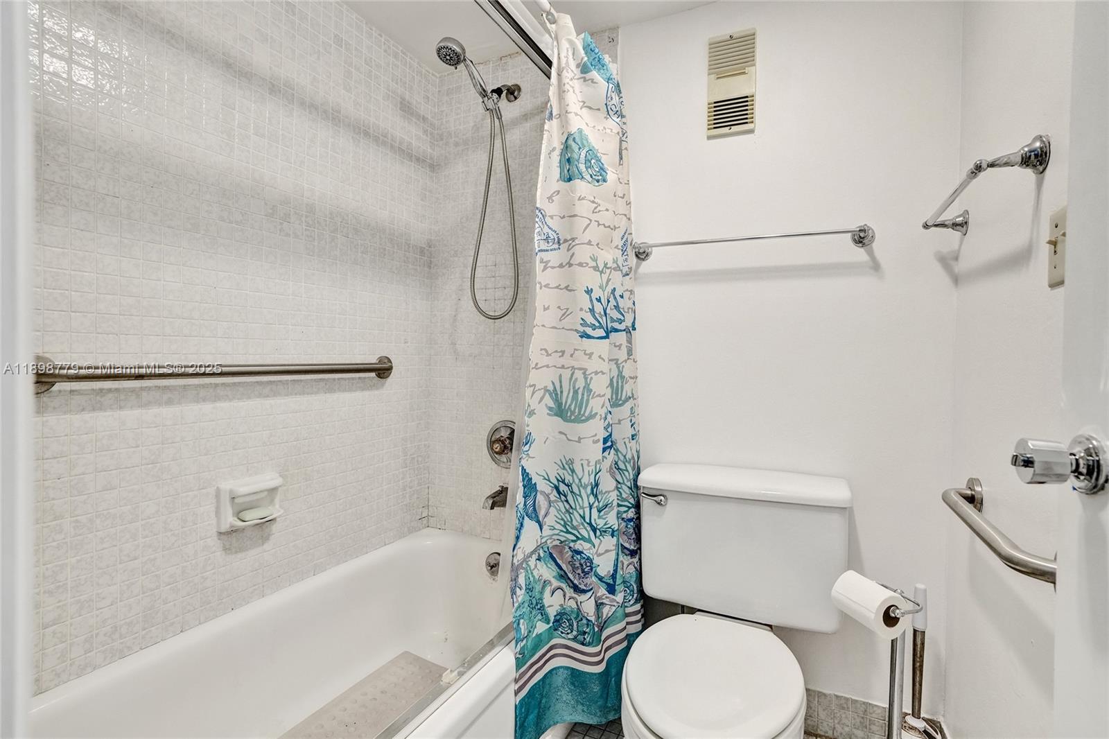 1200 St Charles Place, Unit 413 Pembroke Pines, FL 33026 - Photo 18 of 34 a bathroom with a sink a toilet and shower