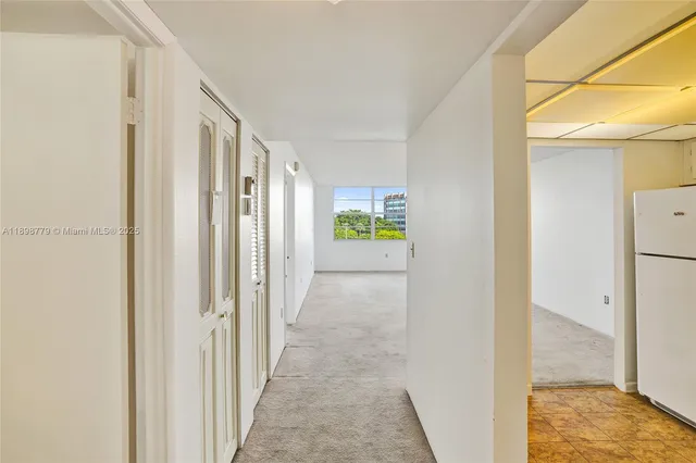 a view of a hallway with wooden shelves