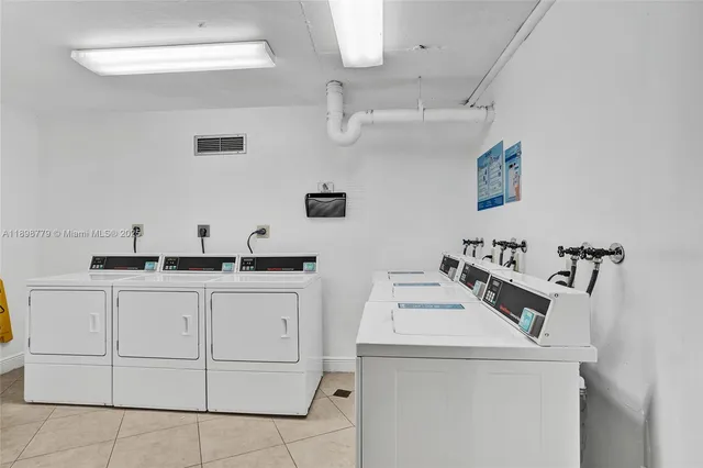 a utility room with sink dryer and washer