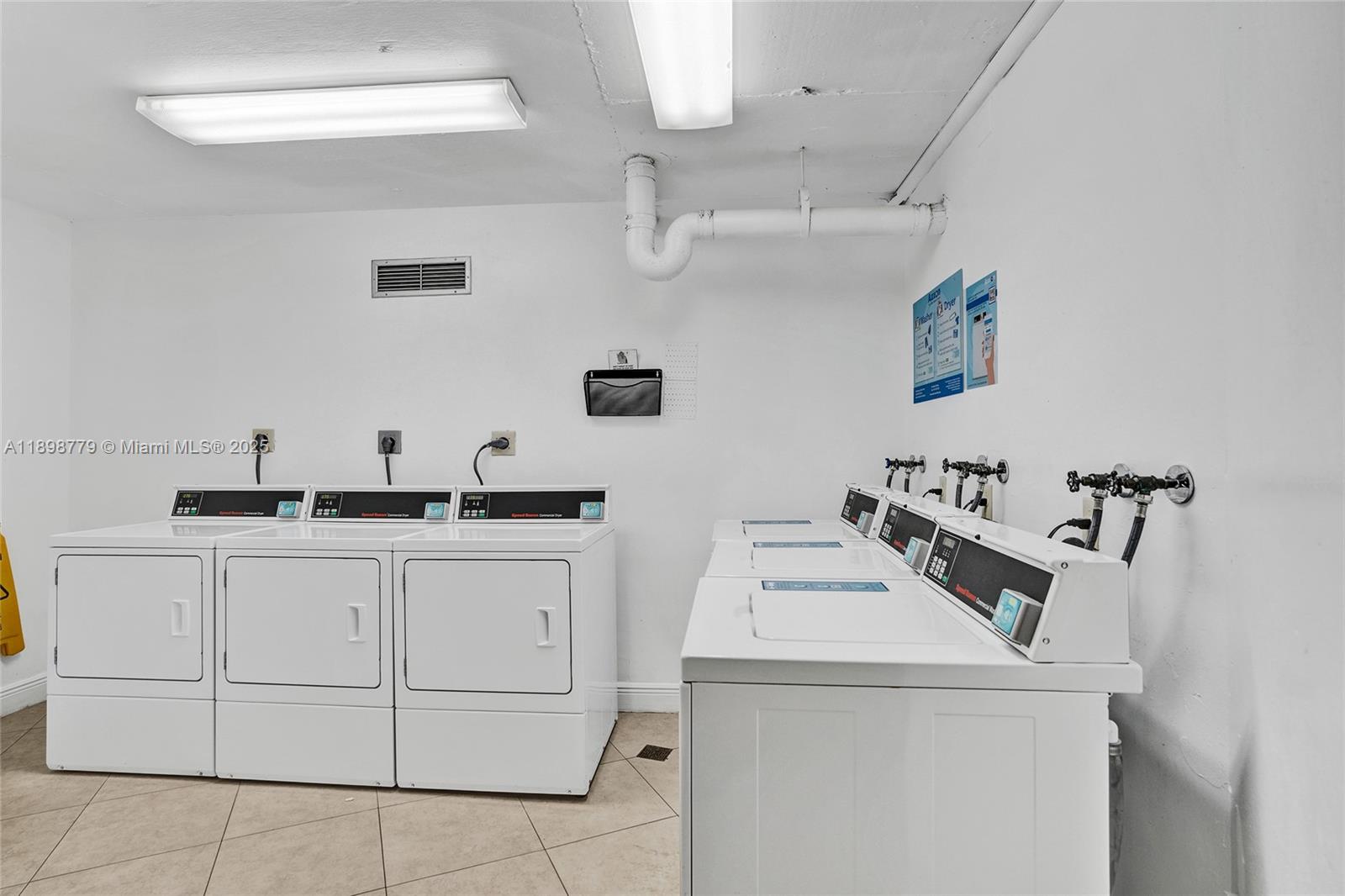 1200 St Charles Place, Unit 413 Pembroke Pines, FL 33026 - Photo 23 of 34 a utility room with sink dryer and washer