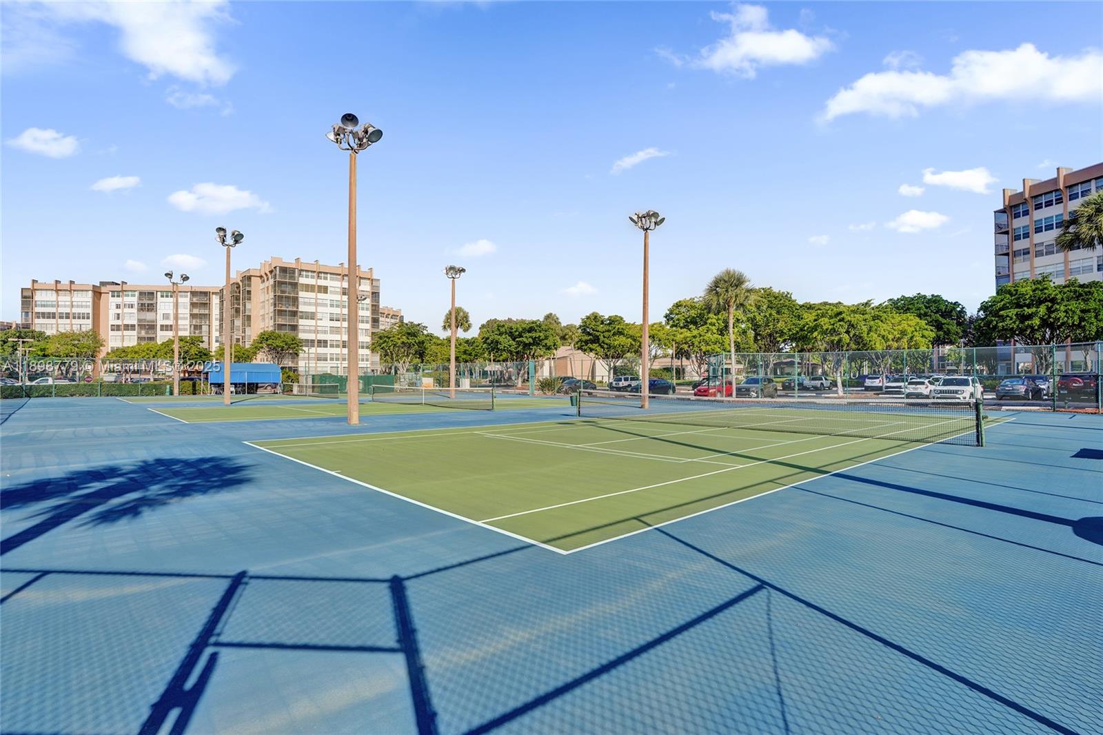 1200 St Charles Place, Unit 413 Pembroke Pines, FL 33026 - Photo 25 of 34 a view of a tennis ground with large trees