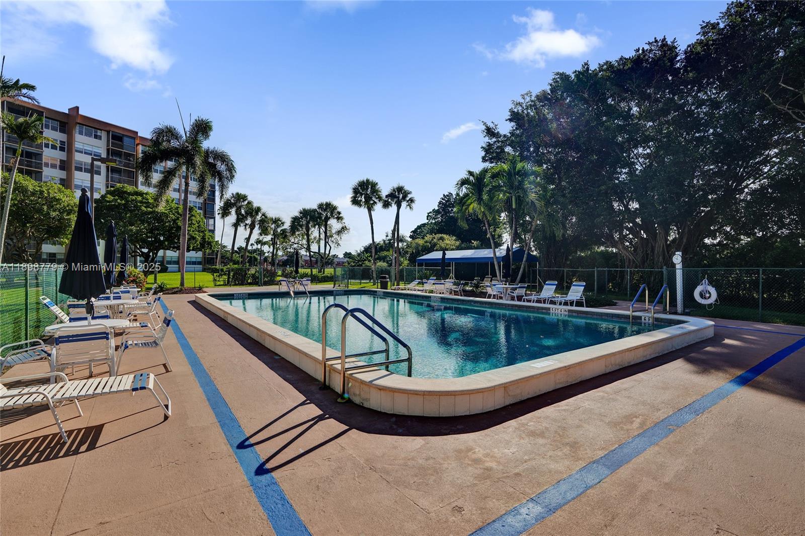 1200 St Charles Place, Unit 413 Pembroke Pines, FL 33026 - Photo 26 of 34 a view of a swimming pool with a patio and a yard