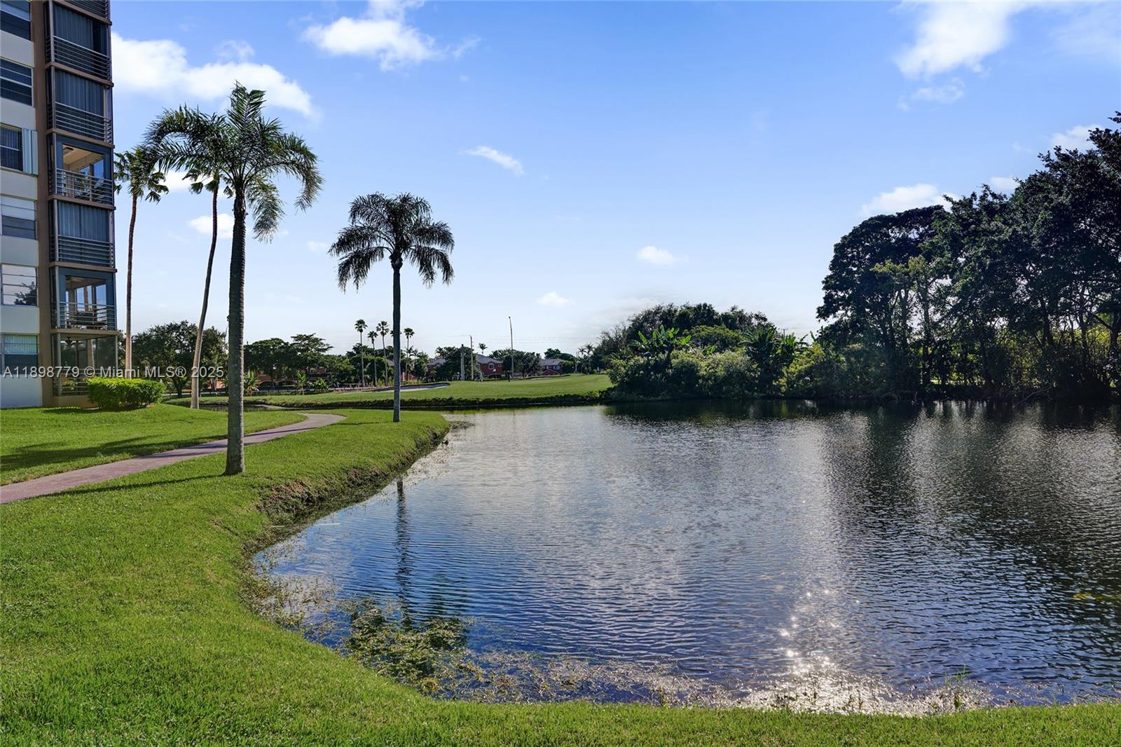 1200 St Charles Place, Unit 413 Pembroke Pines, FL 33026 - Photo 29 of 34 a view of a lake with a yard