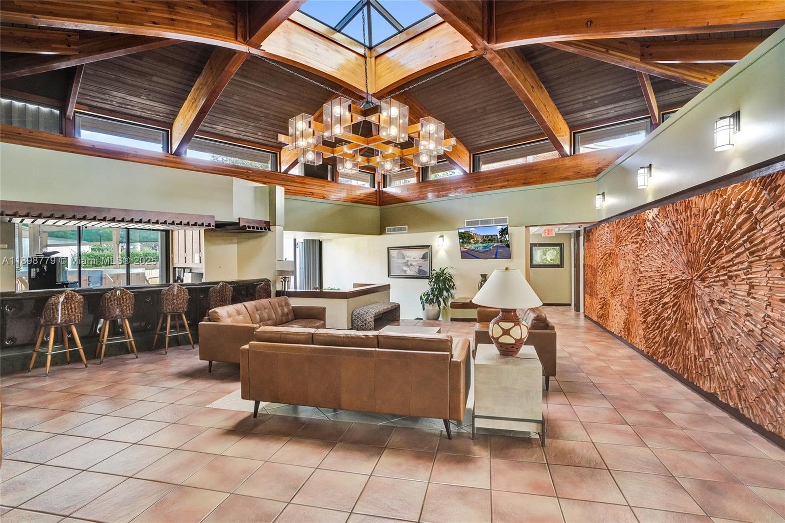 1200 St Charles Place, Unit 413 Pembroke Pines, FL 33026 - Photo 34 of 34 a living room with furniture and a chandelier