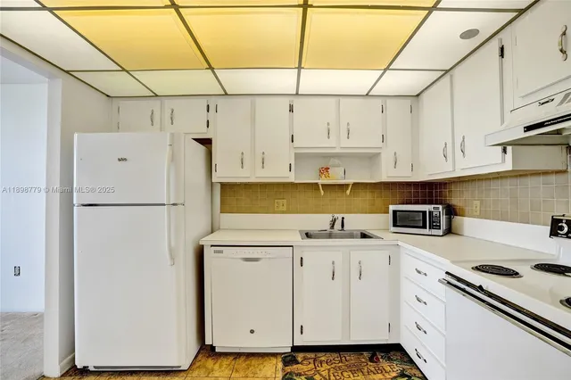a kitchen with stainless steel appliances a refrigerator sink and cabinets