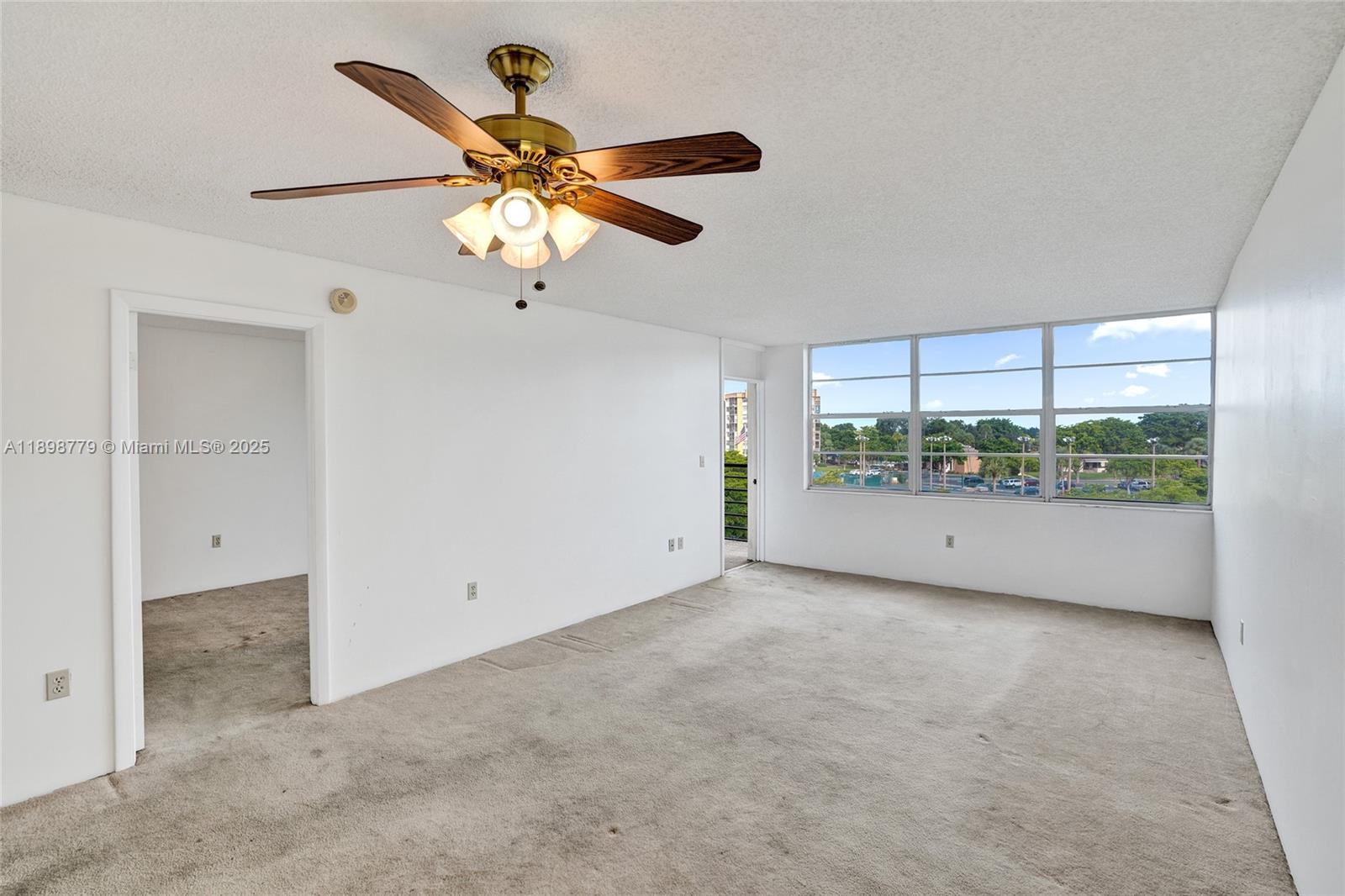 1200 St Charles Place, Unit 413 Pembroke Pines, FL 33026 - Photo 6 of 34 a view of an empty room with a window