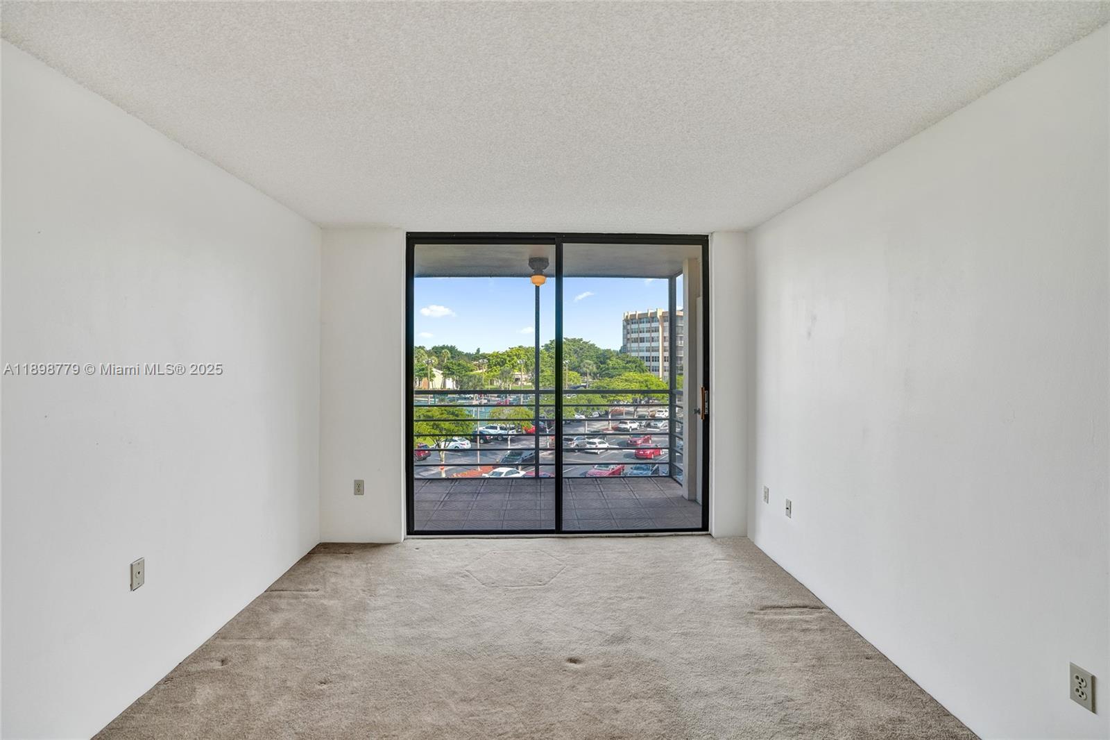 1200 St Charles Place, Unit 413 Pembroke Pines, FL 33026 - Photo 10 of 34 wooden floor in an empty room with a window