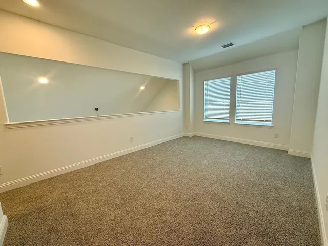 an empty room with a empty space and windows