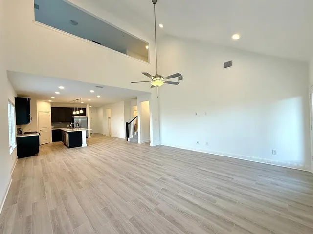 a view of a kitchen with a sink and a floor to ceiling window