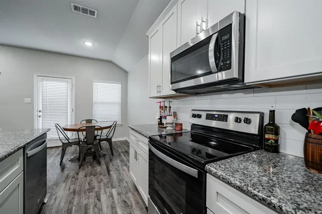 a kitchen with a stove and a microwave