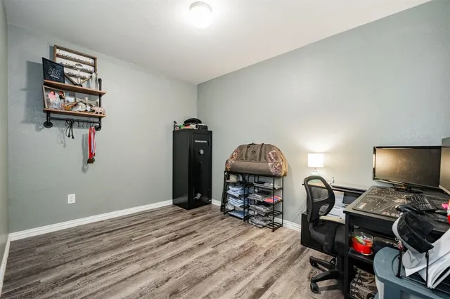 a view of a workspace with furniture and wooden floor