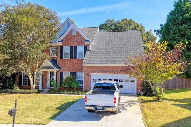 a front view of a house with a yard