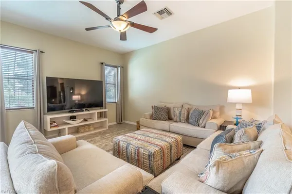 a living room with furniture and a flat screen tv