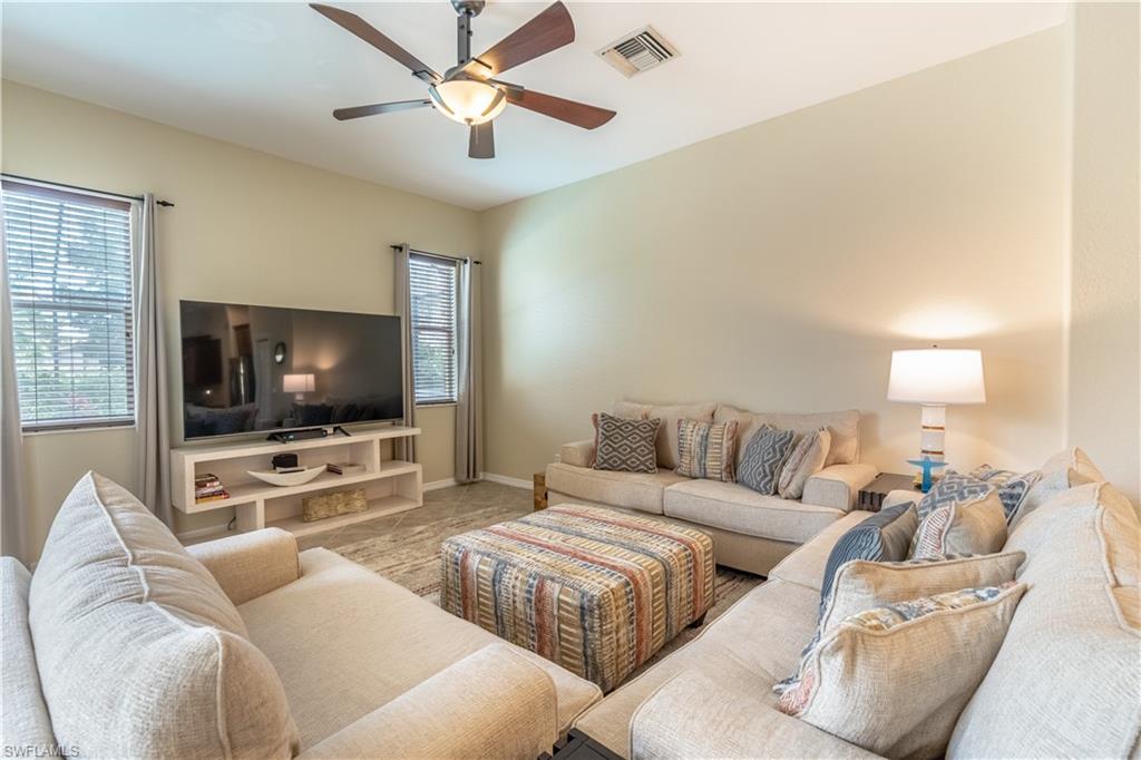 12414 Rock Ridge Lane Fort Myers, FL 33913 - Photo 12 of 48 a living room with furniture and a flat screen tv