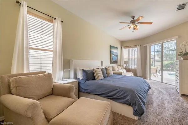 a bedroom with a large bed and a couch