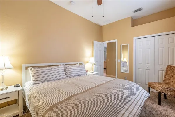 a bedroom with a bed and a chair