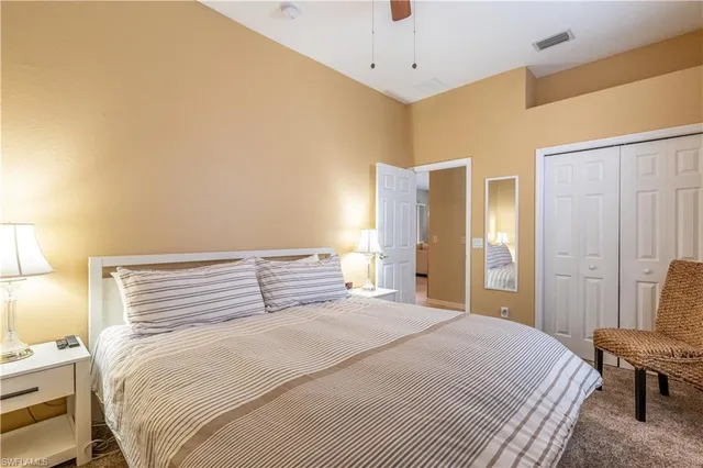 a bedroom with a bed and a chair