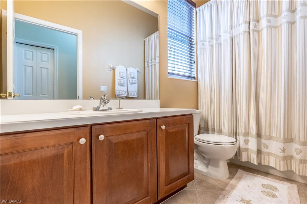 12414 Rock Ridge Lane Fort Myers, FL 33913 - Photo 23 of 48 a bathroom with a double vanity sink toilet and a mirror
