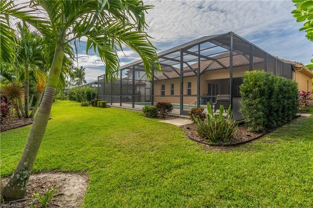 a view of backyard with plants and a patio