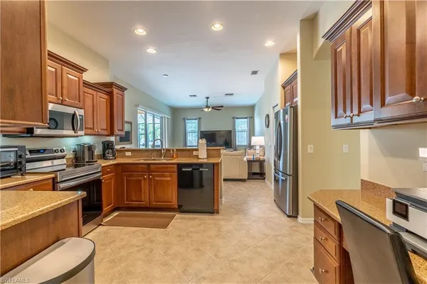 a kitchen with a sink appliances and cabinets