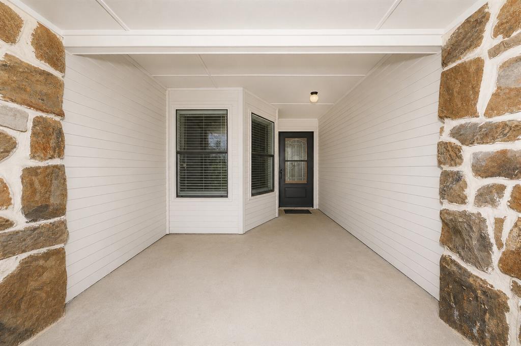1001 Rosebud Drive Azle, TX 76020 - Photo 5 of 36 Covered front entry featuring stone columns and white horizontal paneling