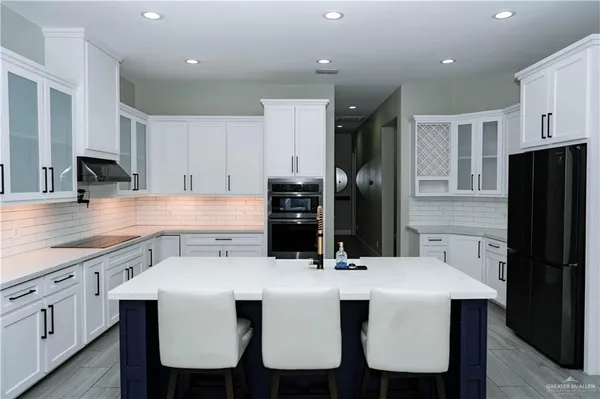 a kitchen with a refrigerator and a sink