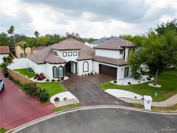 an aerial view of a house with garden space and street view