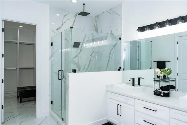 a bathroom with a shower sink and mirror
