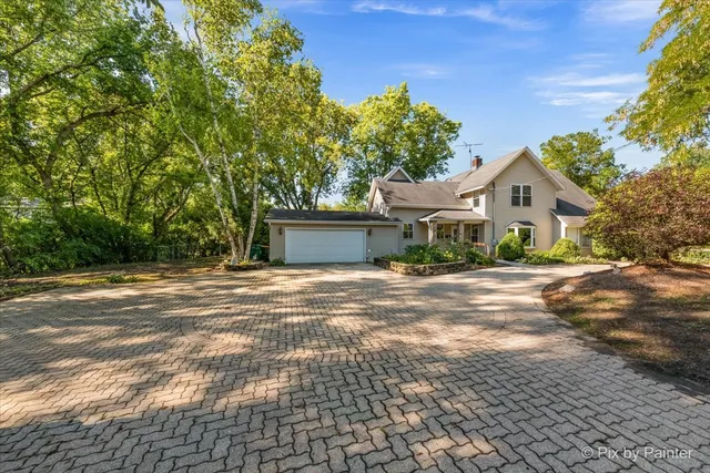 a view of a house with a yard and garage