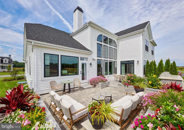 a front view of house with yard and outdoor seating