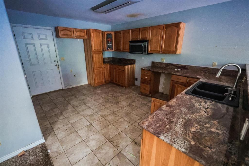 600 County Road 1503 Alba, TX 75410 - Photo 11 of 32 a kitchen with stainless steel appliances granite countertop a sink stove and refrigerator