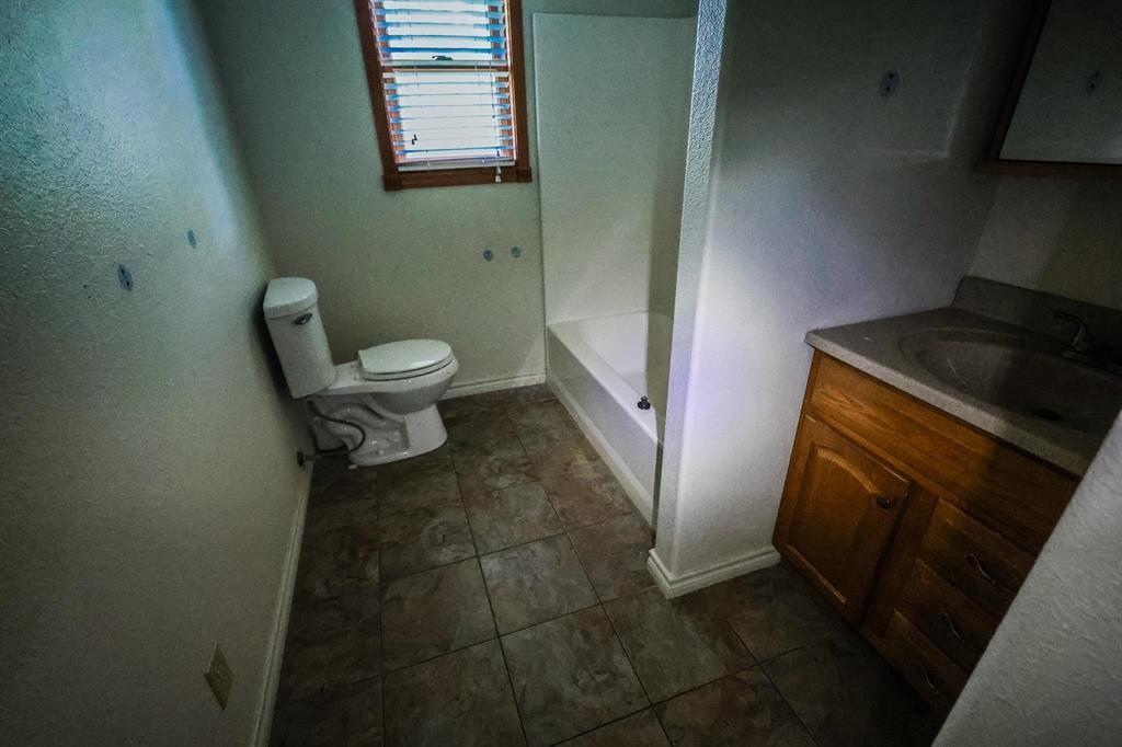 600 County Road 1503 Alba, TX 75410 - Photo 2 of 32 a bathroom with a toilet and a sink