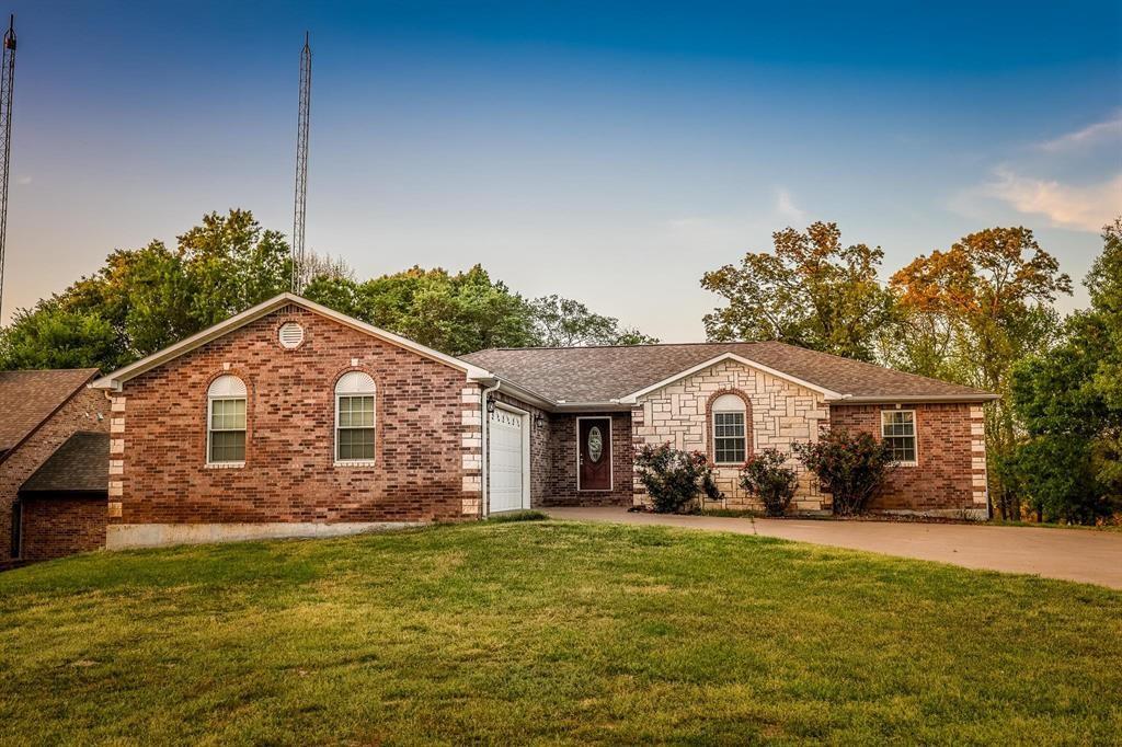 600 County Road 1503 Alba, TX 75410 - Photo 29 of 32 a front view of a house with a garden