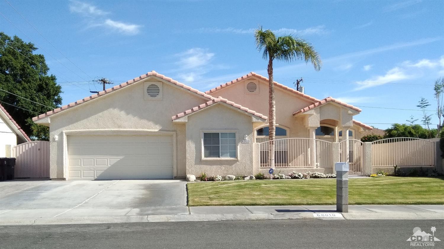 68010 Encinitas Road Cathedral City, CA 92234 - Photo 1 of 1 a front view of a house with a yard and garage