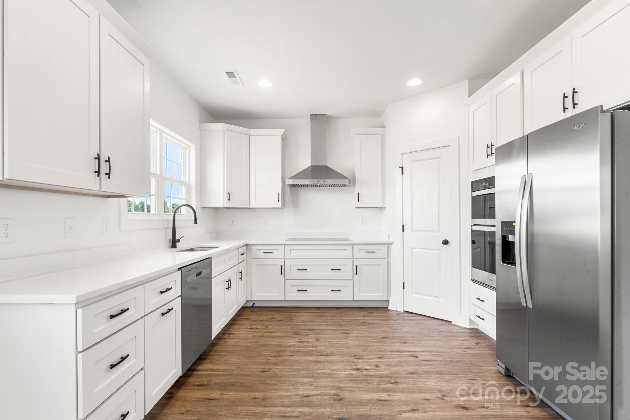 2025 Parks Road Salisbury, NC 28147 - Photo 12 of 47 a kitchen with white cabinets and stainless steel appliances