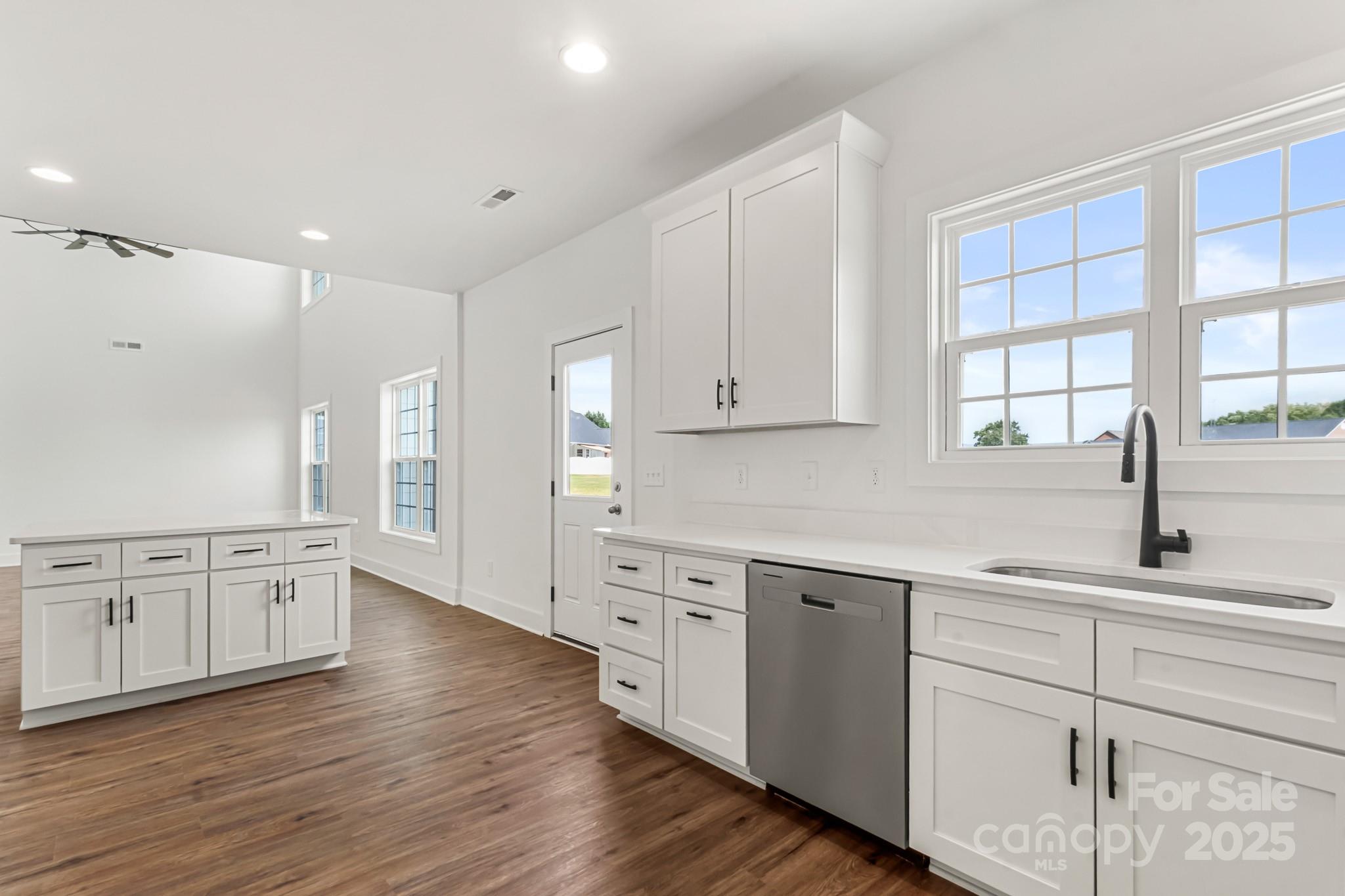 2025 Parks Road Salisbury, NC 28147 - Photo 14 of 47 a kitchen with white cabinets and wooden floor