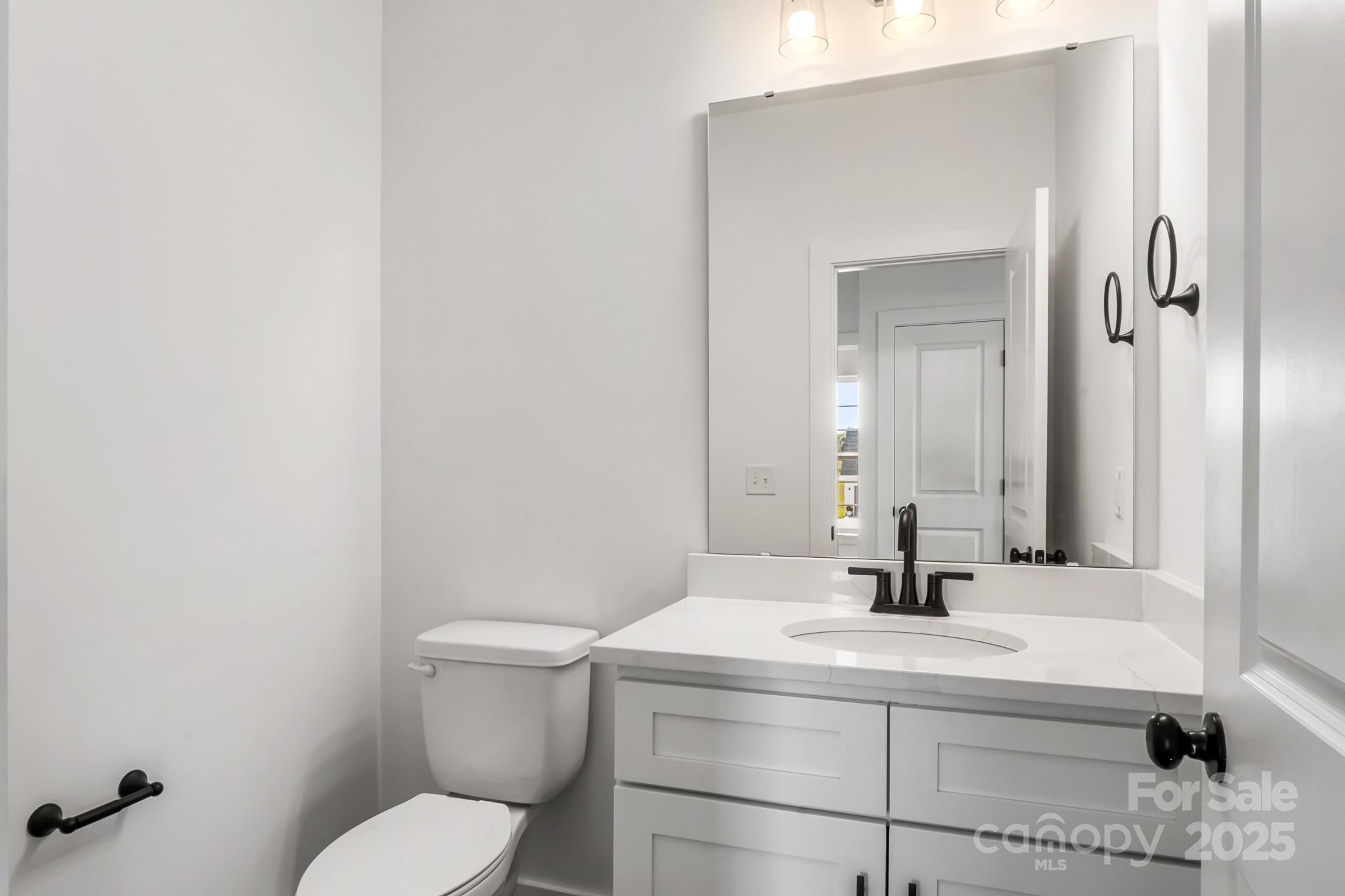 2025 Parks Road Salisbury, NC 28147 - Photo 16 of 47 a bathroom with a toilet a sink and mirror