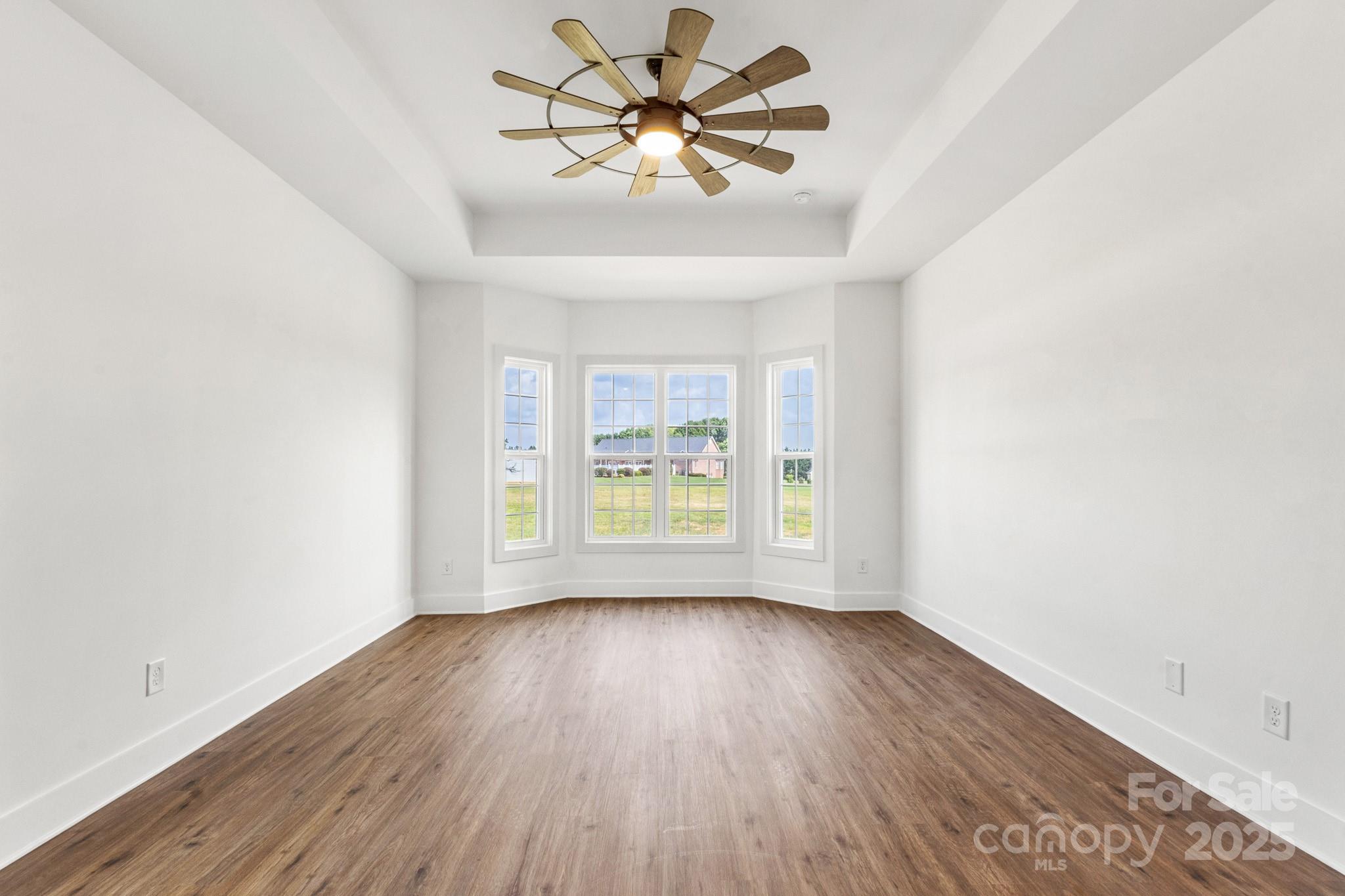2025 Parks Road Salisbury, NC 28147 - Photo 19 of 47 an empty room with wooden floor and windows