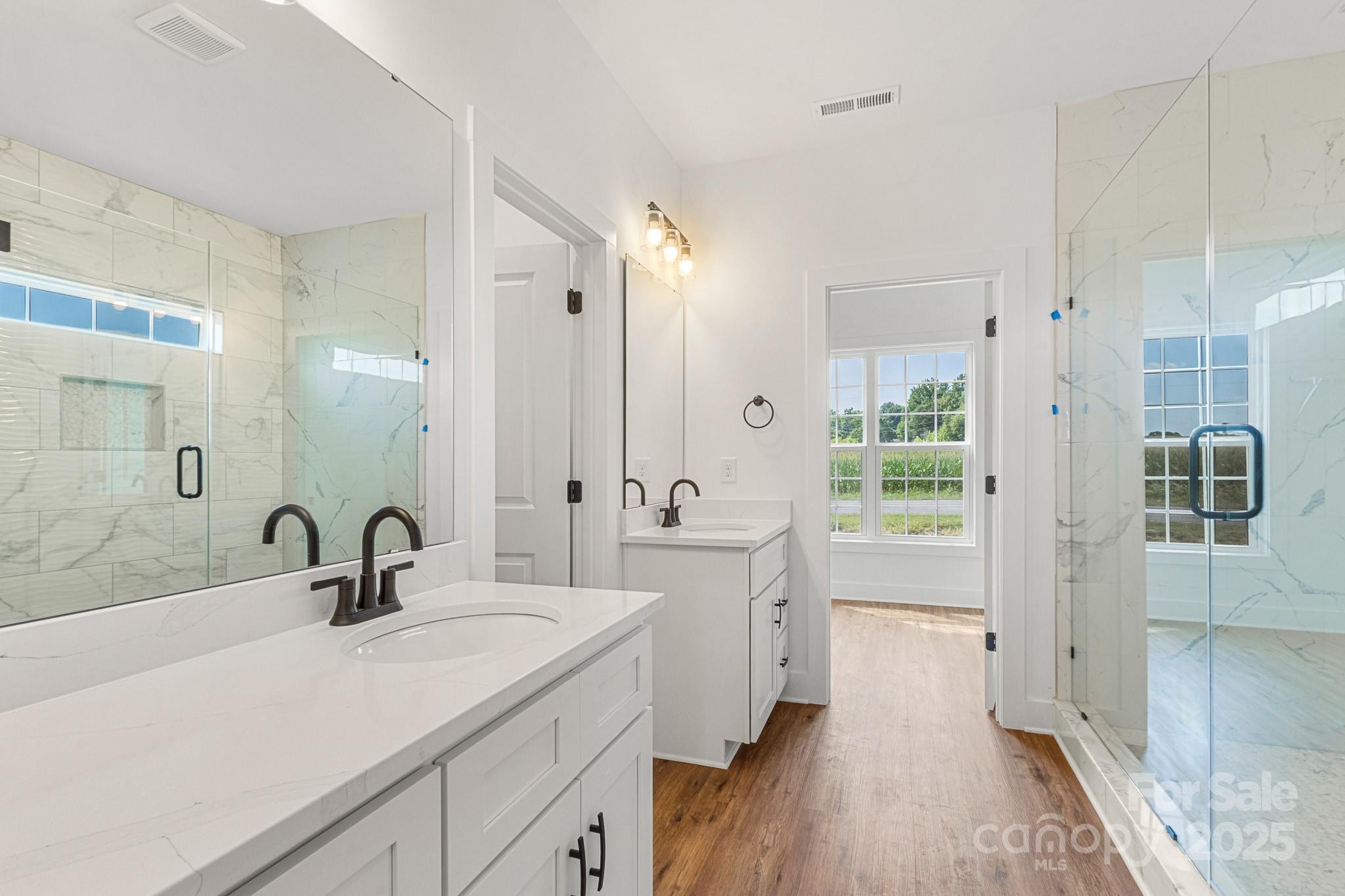 2025 Parks Road Salisbury, NC 28147 - Photo 22 of 47 a bathroom with a double vanity sink a mirror and shower