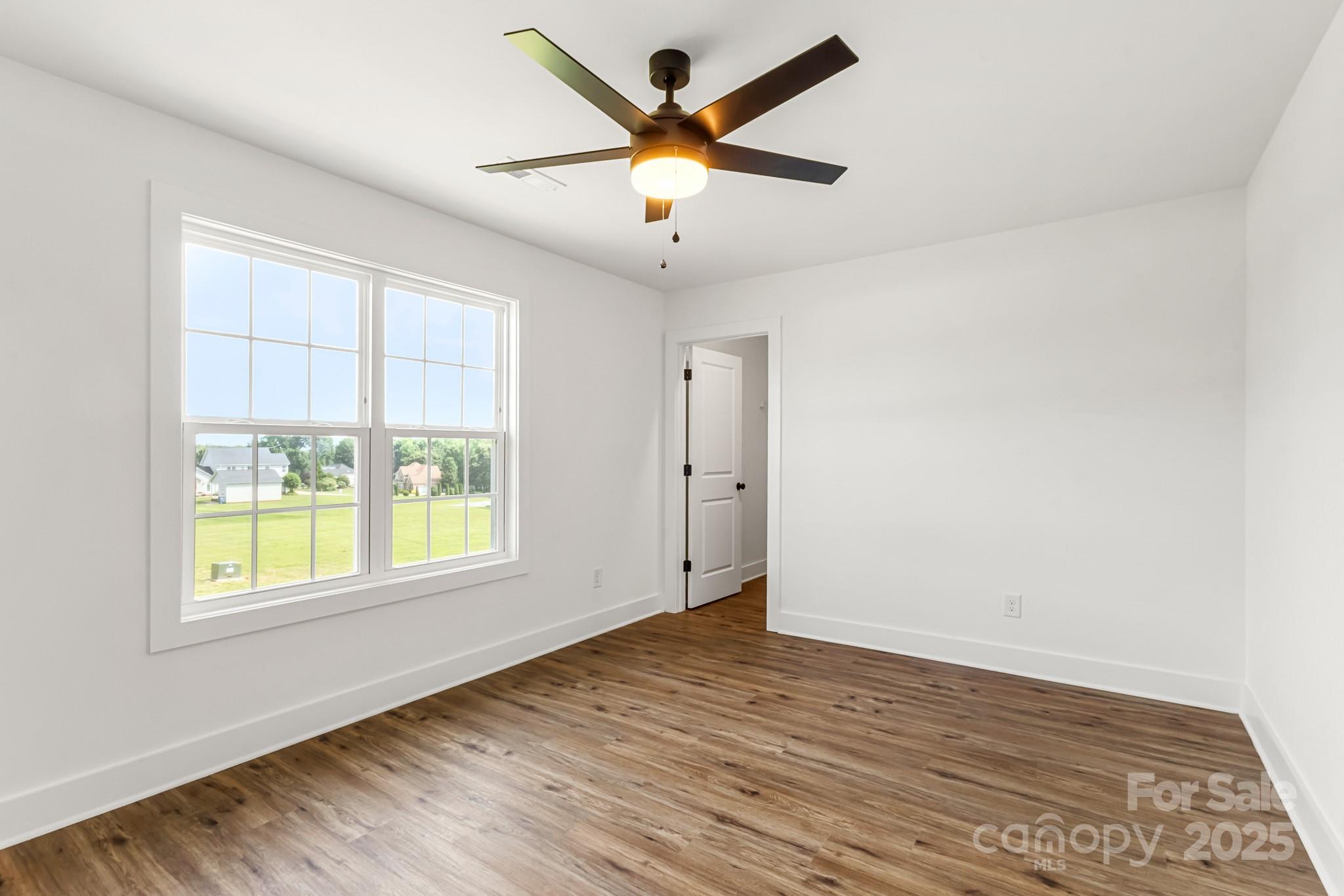 2025 Parks Road Salisbury, NC 28147 - Photo 29 of 47 an empty room with wooden floor and windows