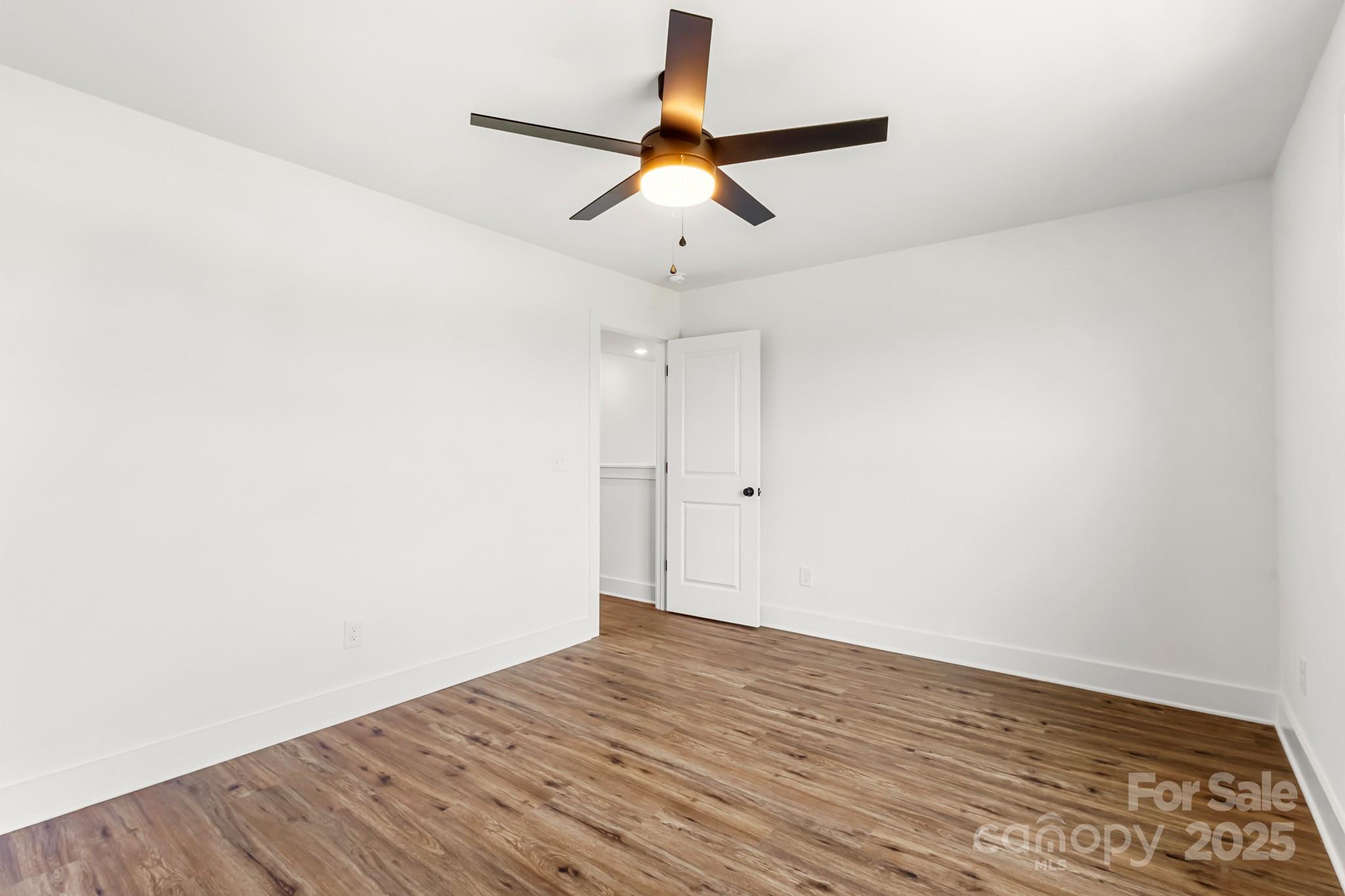 2025 Parks Road Salisbury, NC 28147 - Photo 30 of 47 a view of empty room with wooden floor and fan