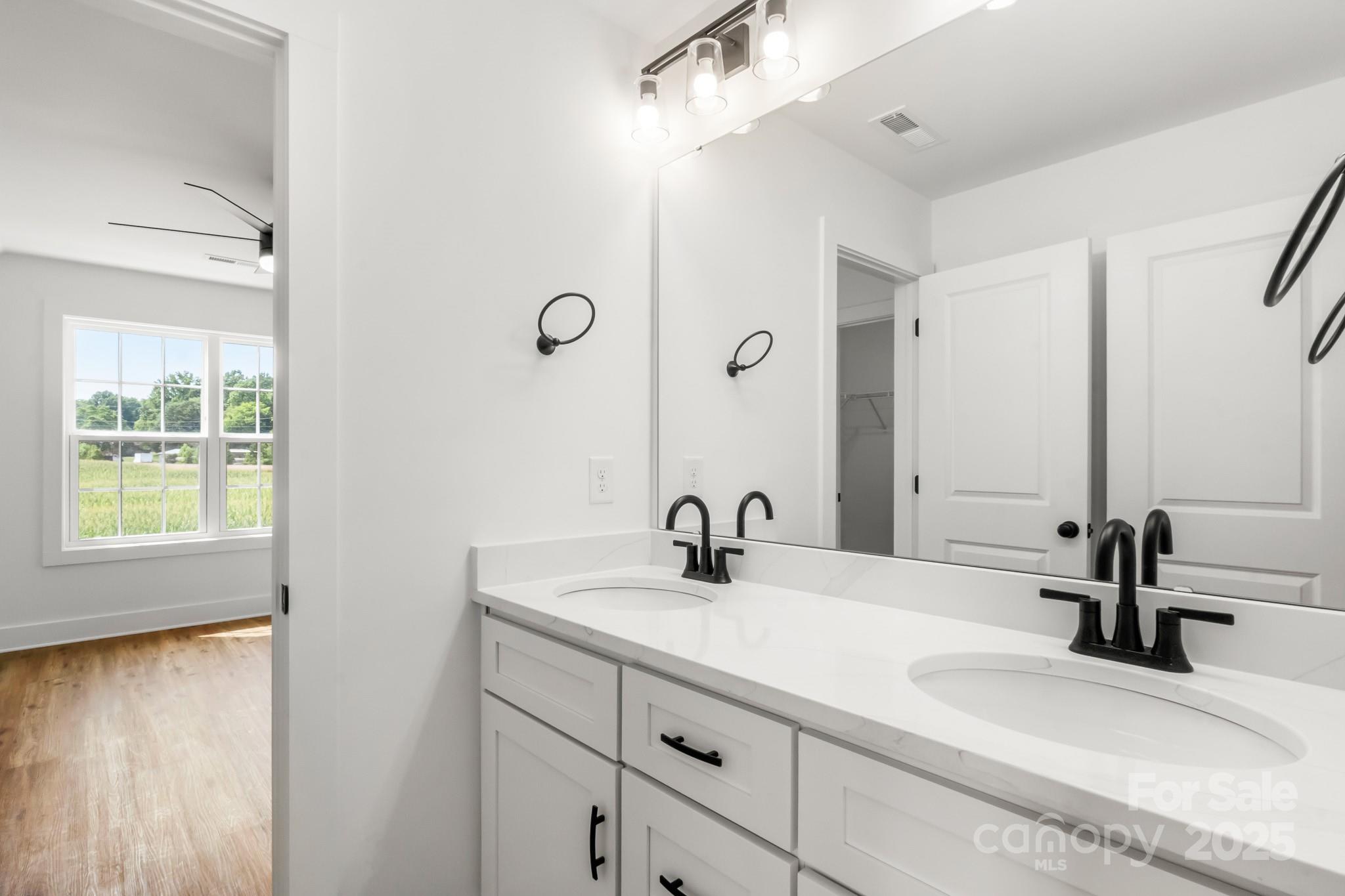 2025 Parks Road Salisbury, NC 28147 - Photo 39 of 47 a bathroom with a double vanity sink and a mirror