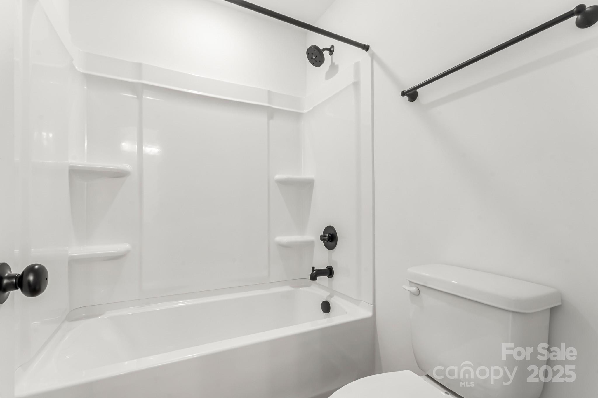 2025 Parks Road Salisbury, NC 28147 - Photo 41 of 47 a bathroom with a shower a toilet and a bathtub